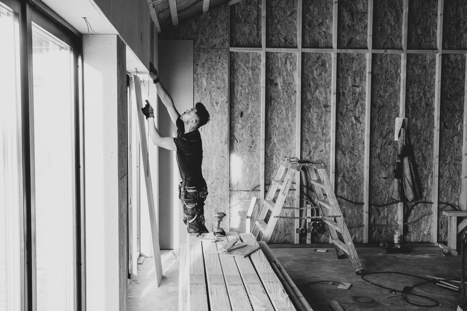 Professional window installation contractor working on a residential home